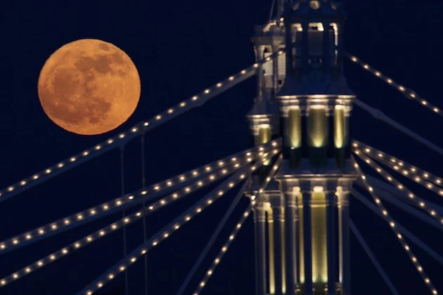 Full Moon Rises Over Albert Bridge In London Full Moon Rises Over Albert Bridge In London